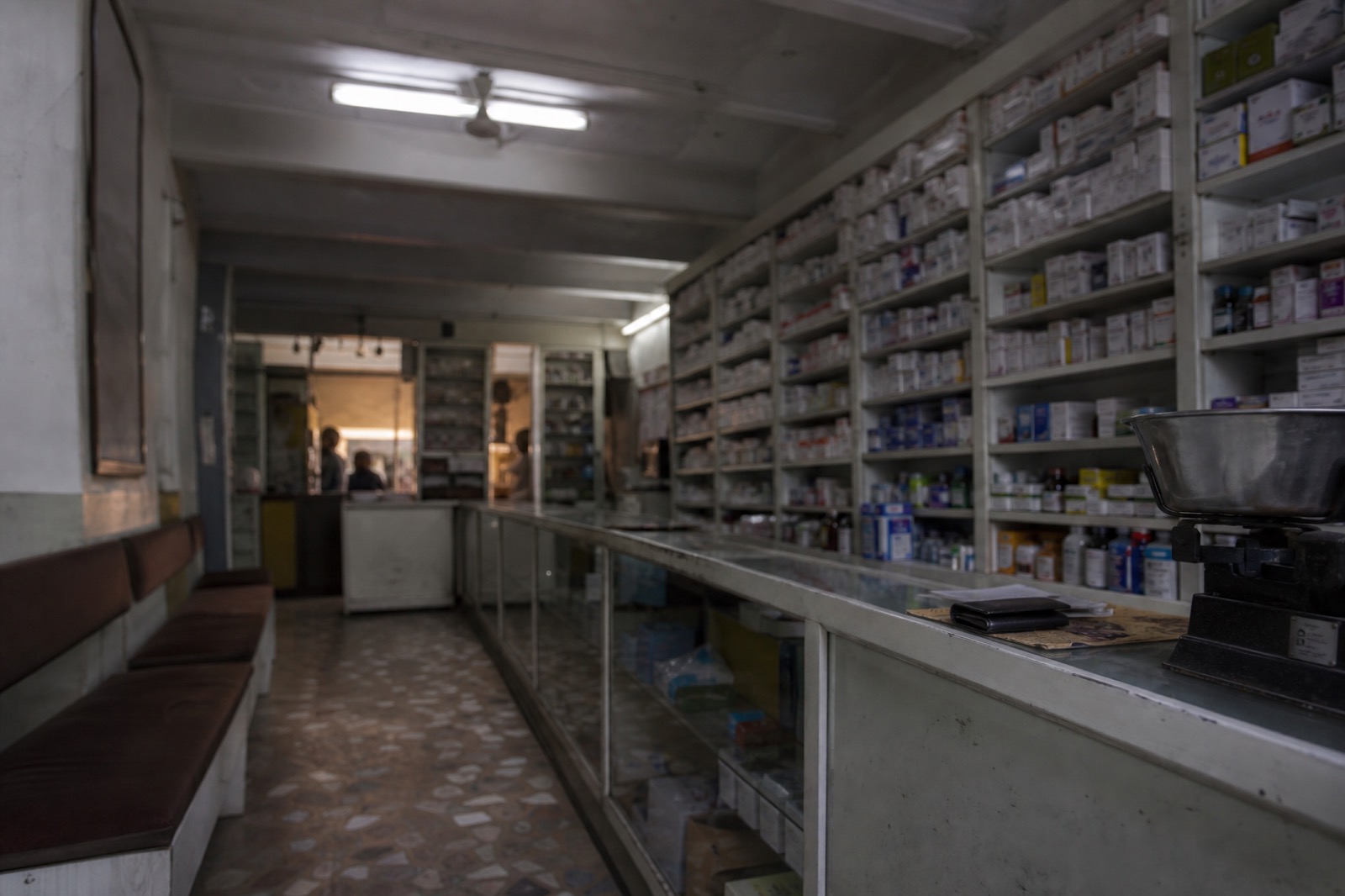 Pharmacy shelving stocked with medicines