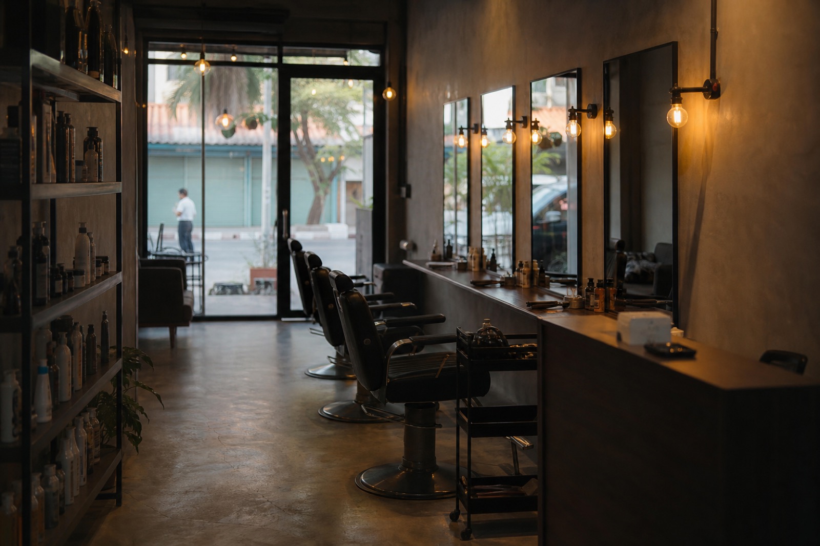 Interior of a small salon with styling chairs and a mirrored wall